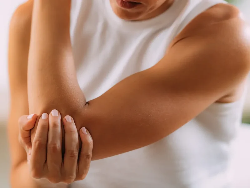 Physical therapist assessing a patient's elbow, wrist and hand movement and mobility