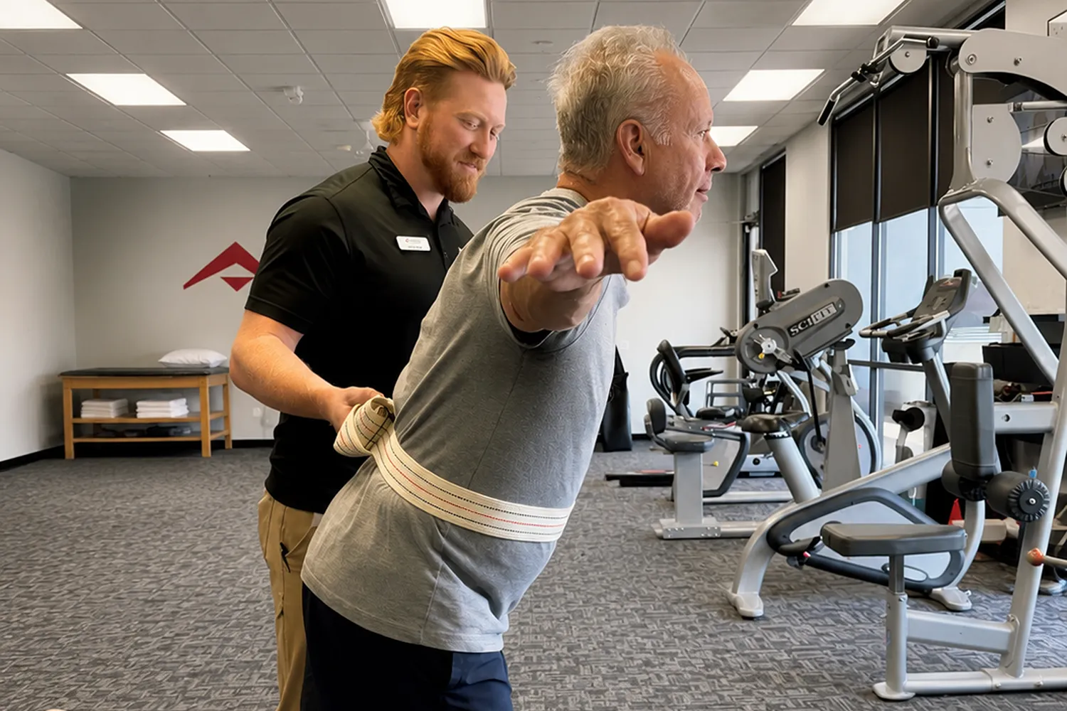 Physical therapist performing gait and balance training with a patient