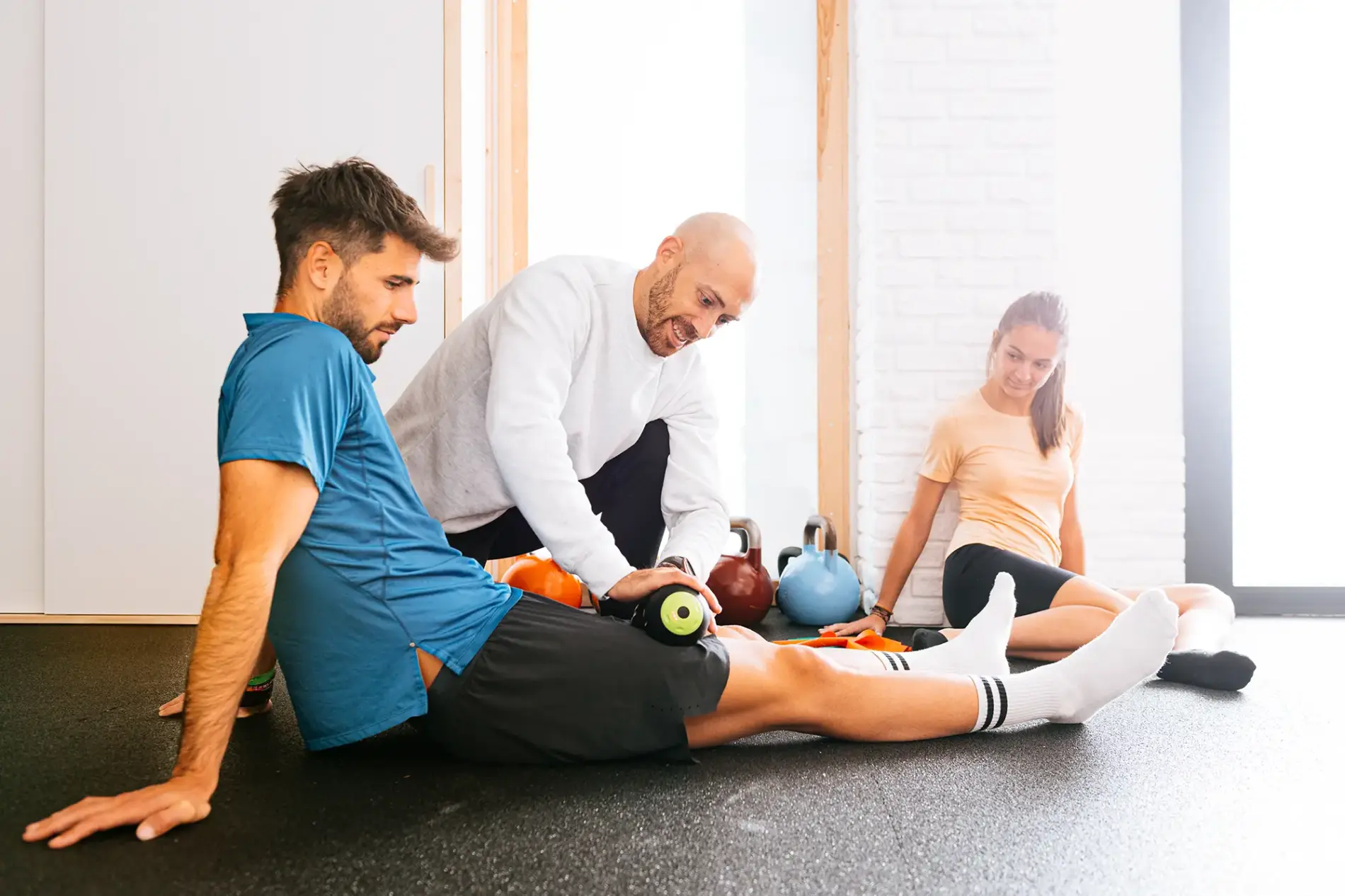 Physical therapist guiding a patient through sports rehab